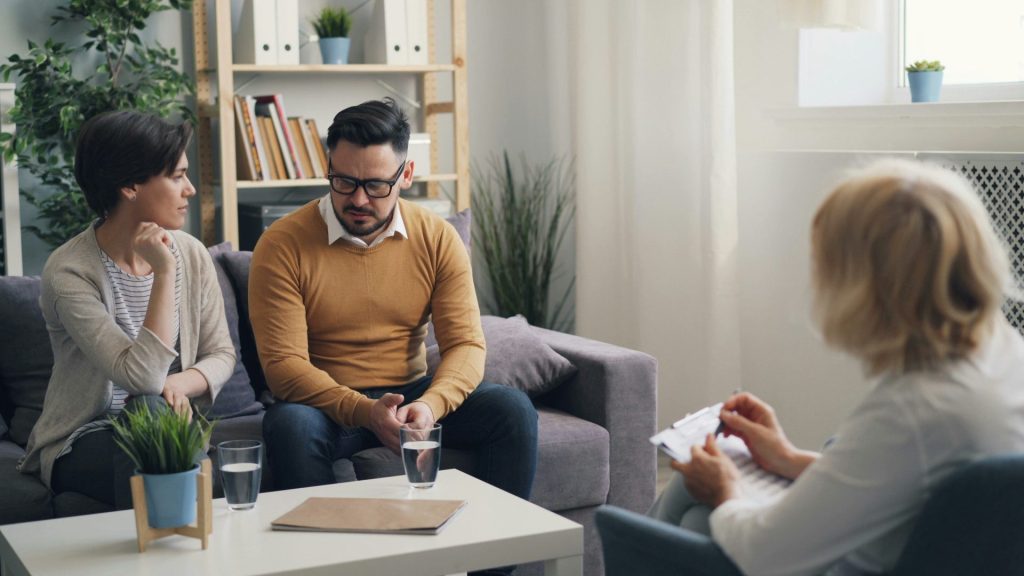a group of people sitting around a living room